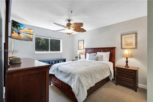 bedroom with light colored carpet, a textured ceiling, and ceiling fan