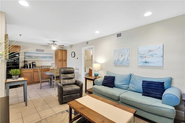 tiled living room with ceiling fan