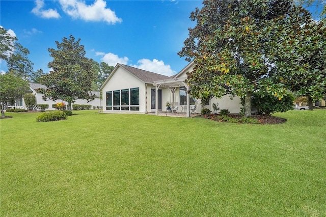 rear view of house with a lawn and a pergola