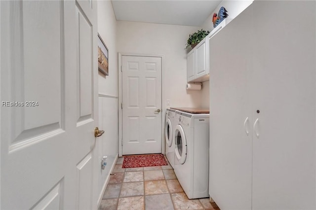 laundry room with cabinets and washing machine and clothes dryer