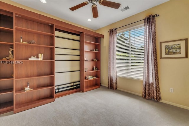 interior space with light carpet and ceiling fan