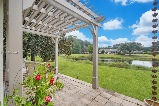 view of patio / terrace with a water view and a pergola