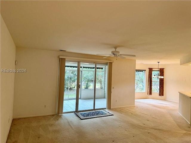 empty room with light carpet and ceiling fan