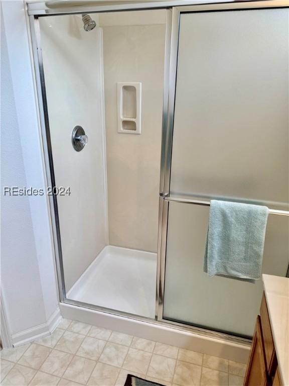 bathroom with vanity and a shower with shower door