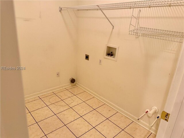 laundry area featuring hookup for a washing machine, gas dryer hookup, tile patterned flooring, and hookup for an electric dryer