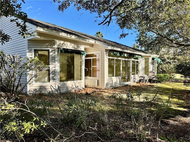 view of side of home featuring a sunroom