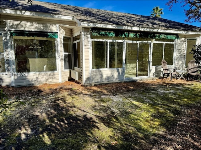 rear view of house with a sunroom