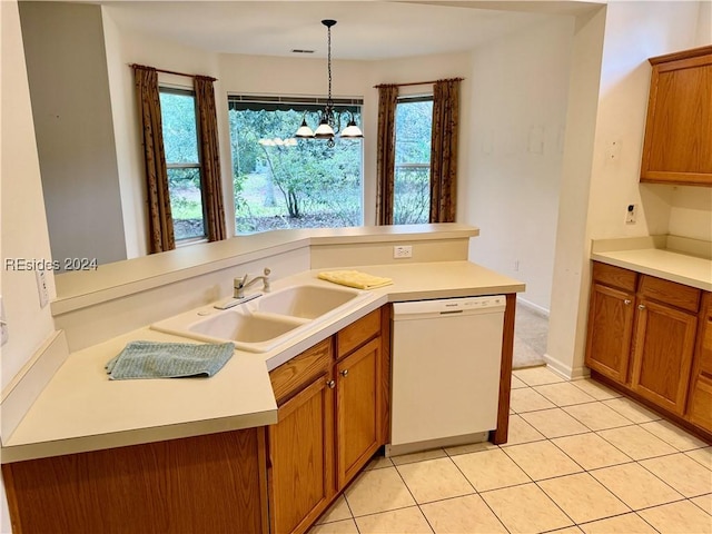 kitchen with pendant lighting, light tile patterned floors, white dishwasher, a notable chandelier, and kitchen peninsula