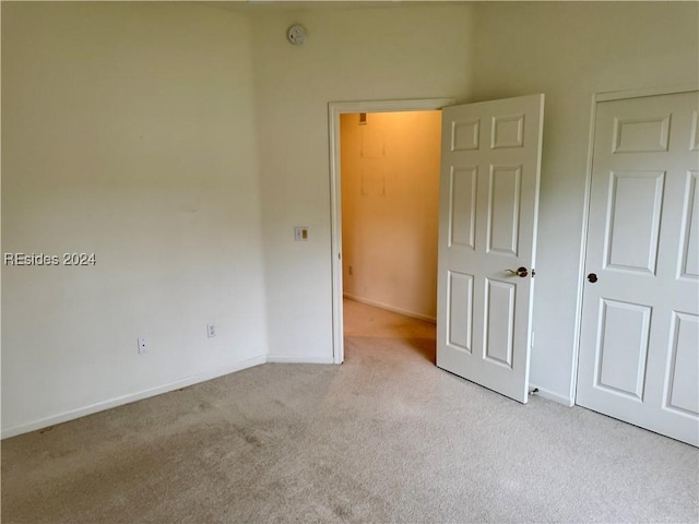 unfurnished bedroom featuring light colored carpet