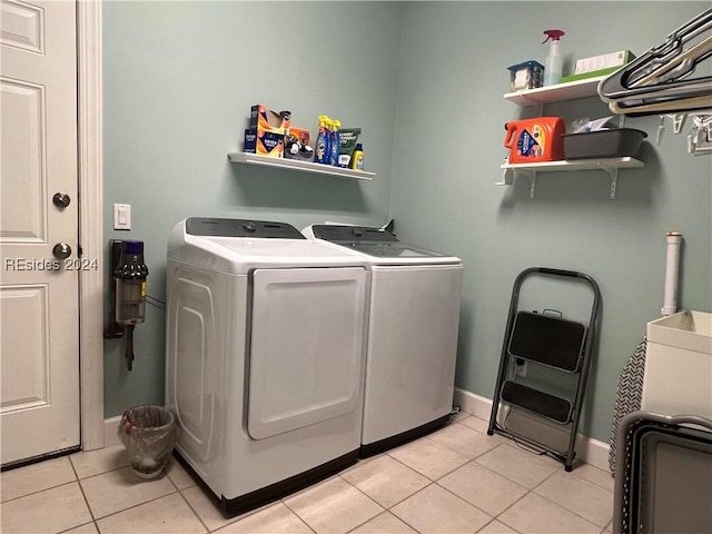 washroom with light tile patterned flooring and washer and clothes dryer