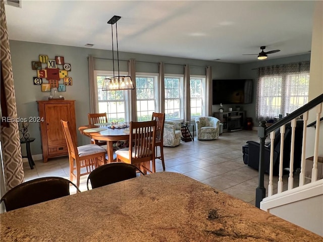 dining area featuring ceiling fan, light tile patterned floors, and a wealth of natural light