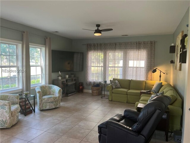 living room with ceiling fan and light tile patterned floors