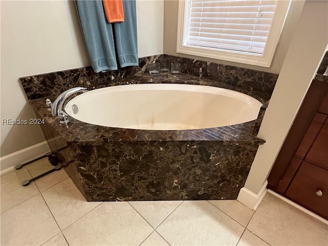 bathroom featuring tiled bath and tile patterned flooring