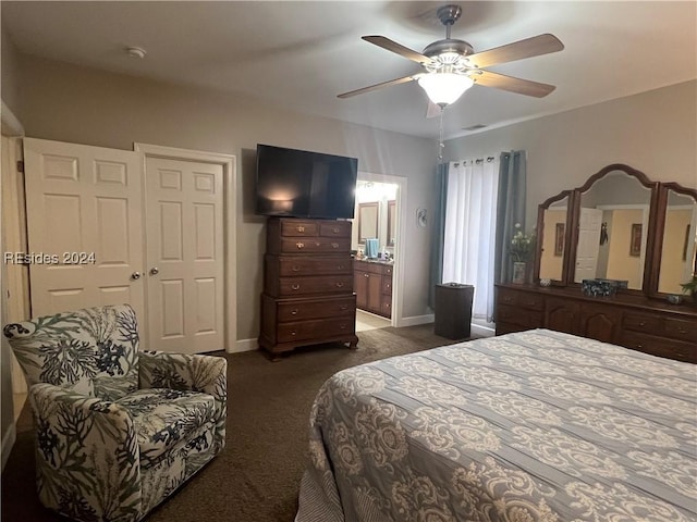 bedroom featuring ensuite bath, dark carpet, ceiling fan, and a closet