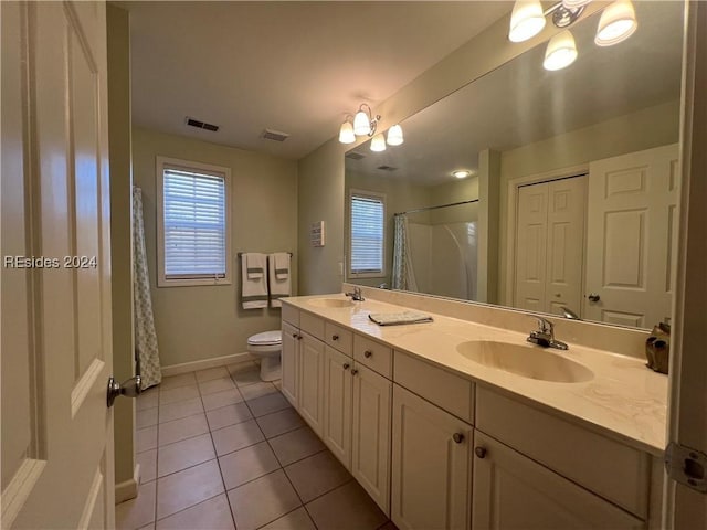 bathroom featuring tile patterned floors, toilet, a shower with shower curtain, and vanity