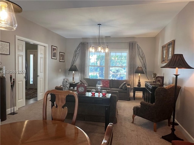 carpeted living room featuring a notable chandelier