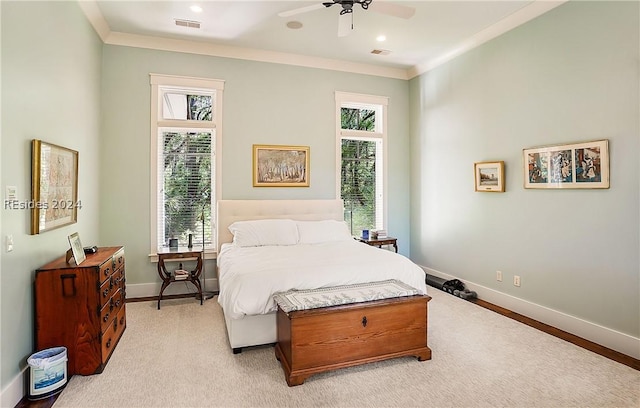 carpeted bedroom with crown molding and ceiling fan