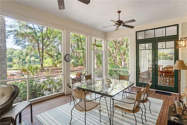 sunroom / solarium with a wealth of natural light, ceiling fan, and french doors