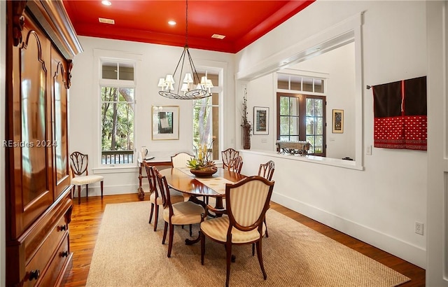 dining space featuring an inviting chandelier and hardwood / wood-style flooring