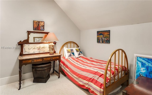 bedroom featuring lofted ceiling and carpet