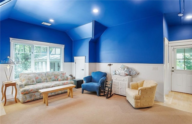 living room featuring carpet flooring, vaulted ceiling, and plenty of natural light