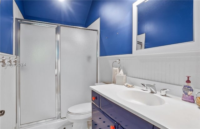 bathroom featuring a shower with door, vanity, lofted ceiling, and toilet