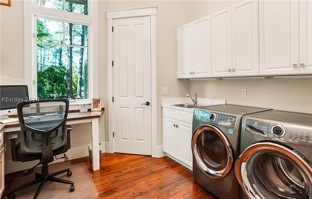 laundry room featuring separate washer and dryer, sink, dark hardwood / wood-style flooring, and cabinets