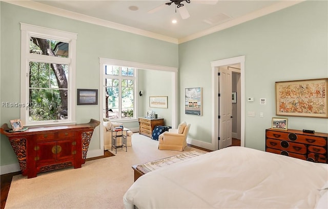 bedroom with crown molding, ceiling fan, and multiple windows