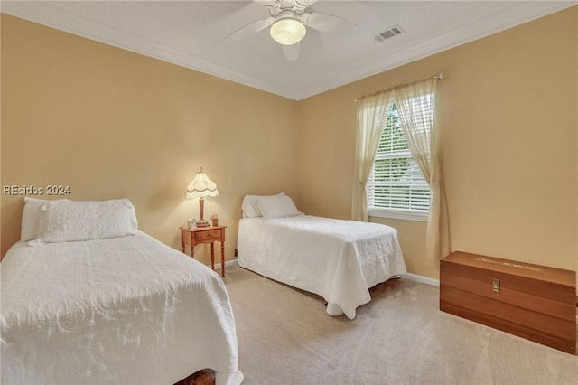 bedroom with ornamental molding, carpet, and ceiling fan