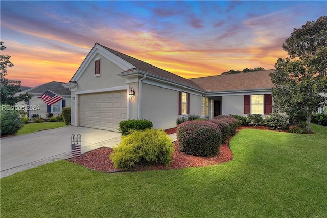 ranch-style home with a garage and a yard