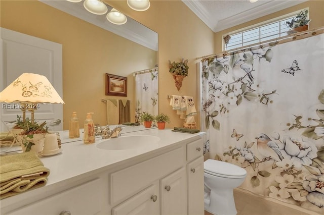 bathroom with vanity, crown molding, and toilet