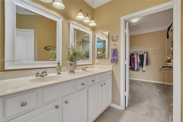 bathroom featuring tile patterned flooring, vanity, ornamental molding, and a textured ceiling