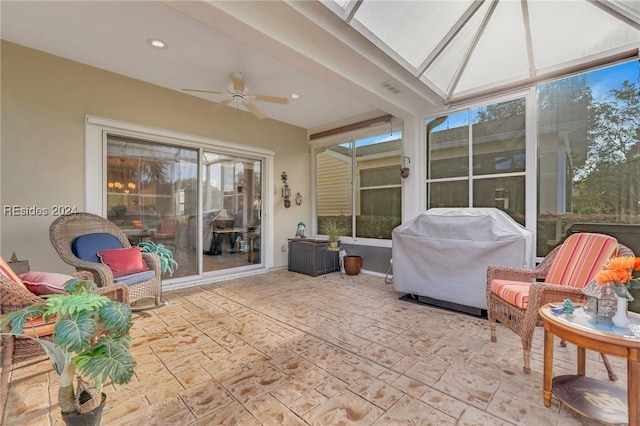 sunroom / solarium with a skylight and ceiling fan