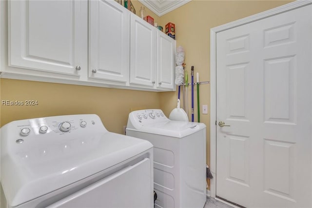 clothes washing area featuring separate washer and dryer, crown molding, and cabinets