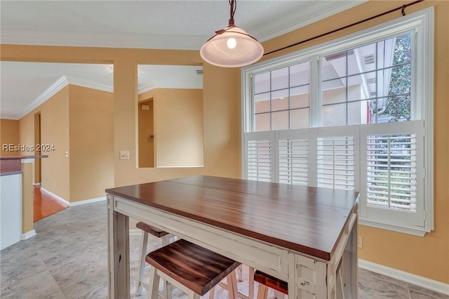 dining space featuring crown molding