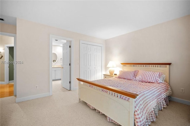 bedroom featuring light colored carpet, connected bathroom, and a closet