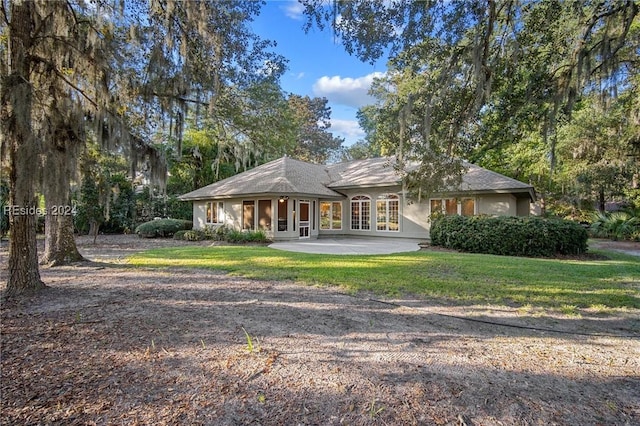 ranch-style home with french doors, a patio, and a front yard