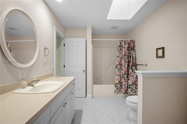 full bathroom featuring vanity, toilet, a skylight, and shower / bath combo