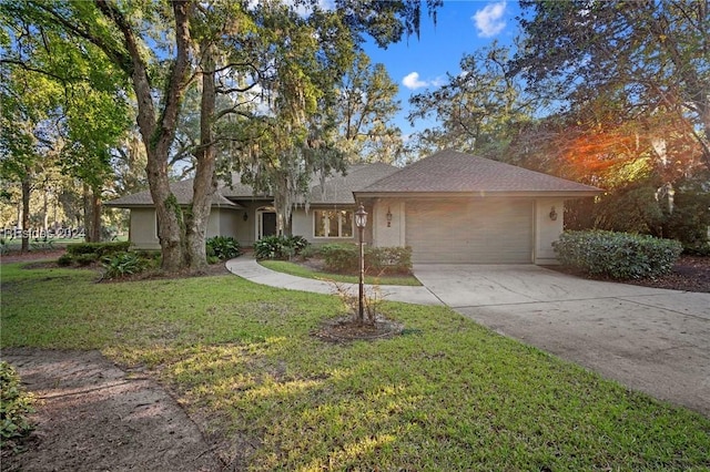 single story home featuring a garage and a front yard