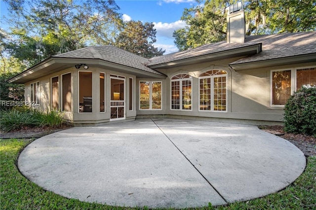 rear view of property featuring a patio