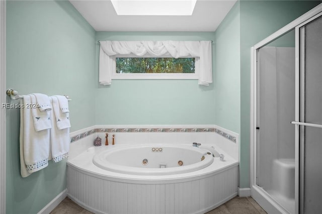 bathroom featuring a skylight, tile patterned floors, and separate shower and tub