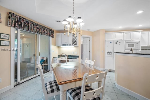 tiled dining area featuring a chandelier