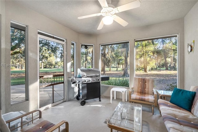 sunroom / solarium with plenty of natural light and ceiling fan