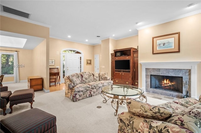 living room with crown molding, light colored carpet, and a fireplace