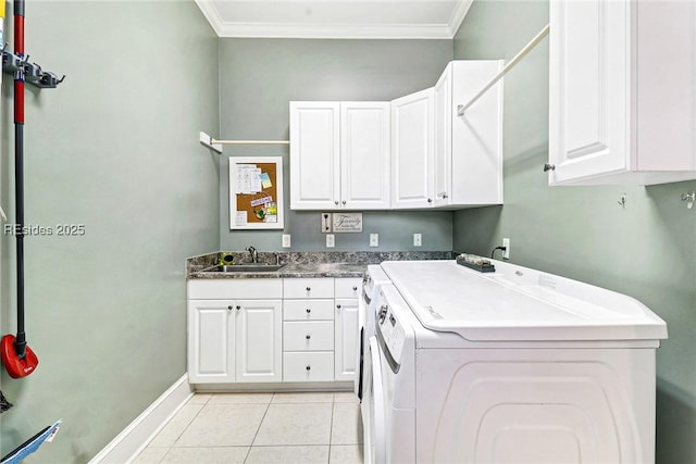 clothes washing area featuring sink, crown molding, light tile patterned floors, cabinets, and independent washer and dryer