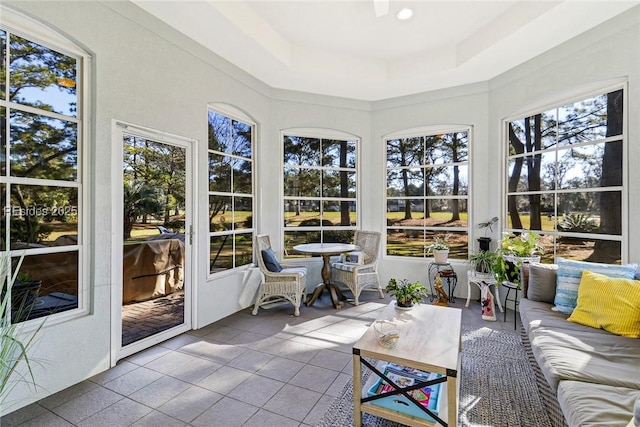 sunroom / solarium featuring a raised ceiling