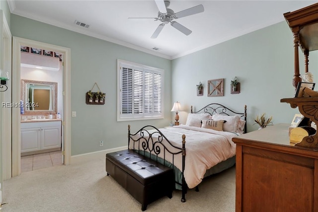 bedroom featuring ensuite bathroom, crown molding, light colored carpet, and ceiling fan