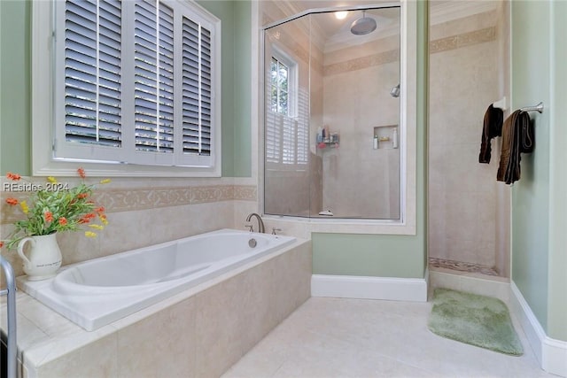 bathroom with tile patterned floors and shower with separate bathtub