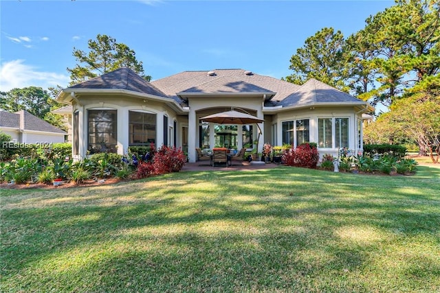 back of house featuring a yard and a patio