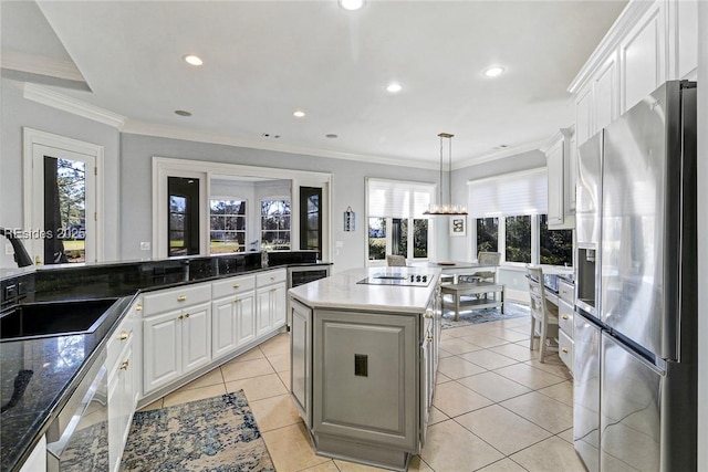 kitchen featuring pendant lighting, sink, appliances with stainless steel finishes, white cabinets, and a kitchen island